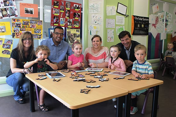 L-R Centre Director Jo Mavrigiannakis, parent Sam Khalil, Early Childhood Teacher Melissa-Rae Oakley and Angus Taylor, with children Rhys Brooker, Phoebe Dalley, Shelby Smyth and Harper Tarplee practising on their ipads before the language trial begins next year.